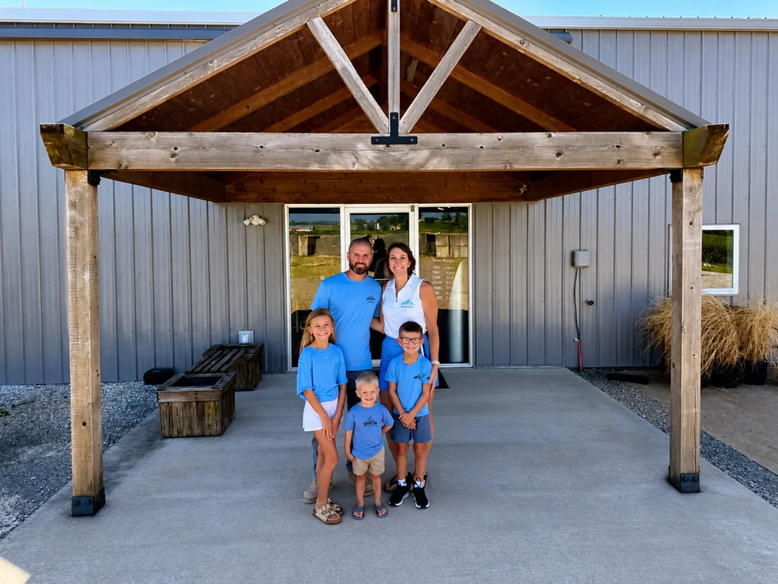 Brandon and Brooke Smith with their three children in front of Smith Heating, Air & Sheet Metal in Steeleville, IL